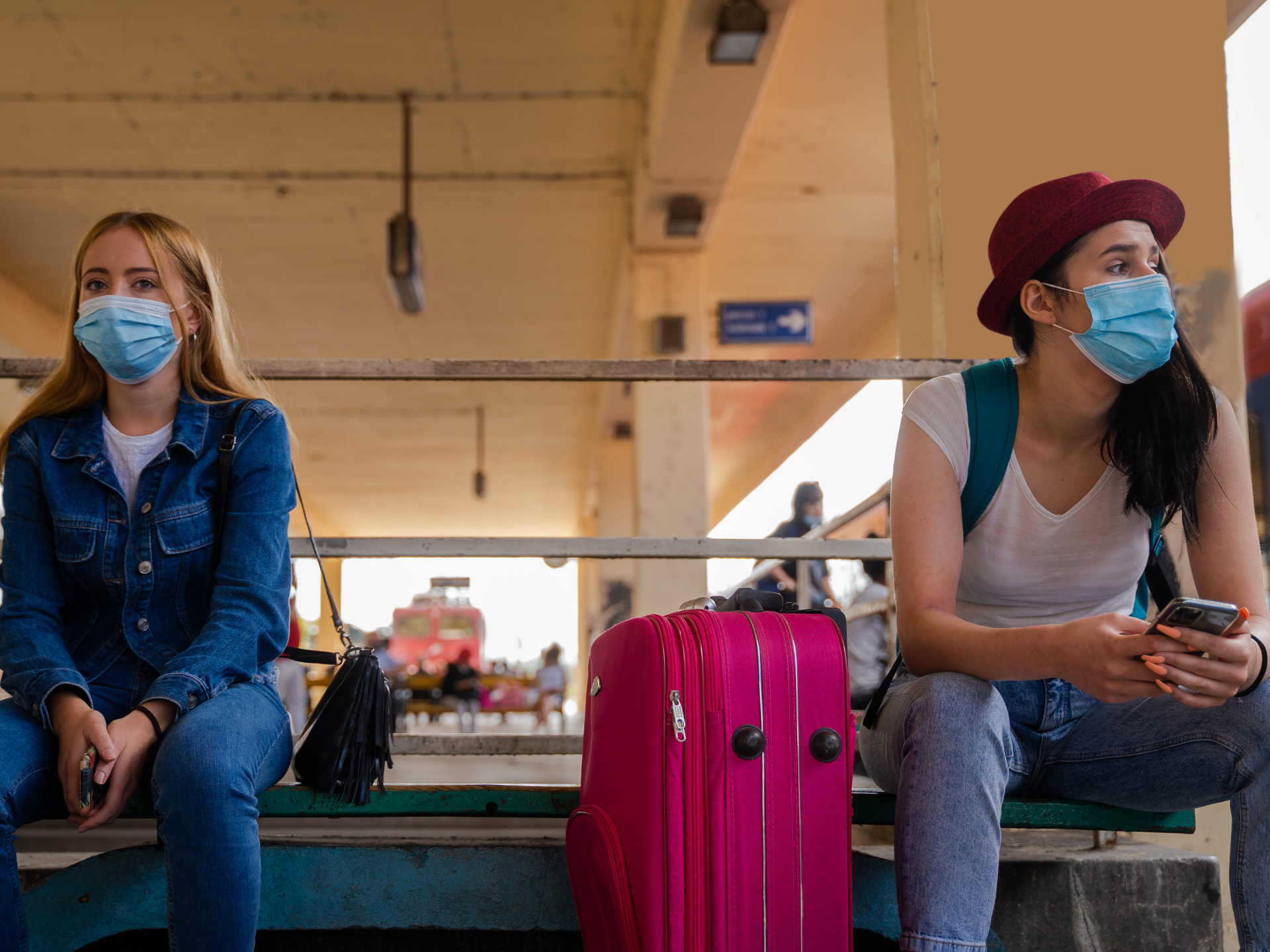 Two Ladies Observing Safety at Airport Lounge