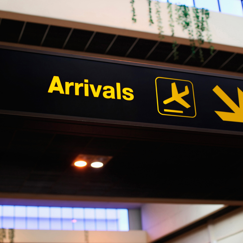 Arrivals. Arrival Airport. Luton Airport with text. To the City Airport signs. Arrived board