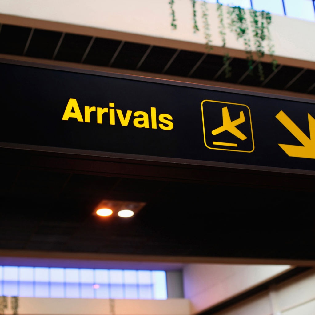 Arrived board. Arrivals. Arrival Airport. Luton Airport with text. To the City Airport signs.